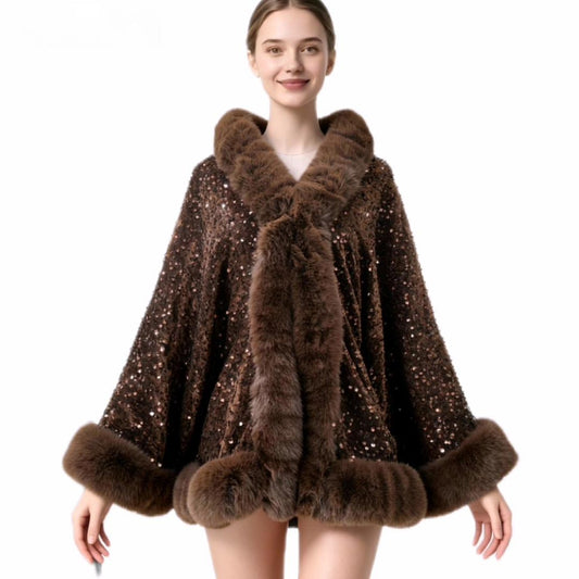 A woman modeling a brown fur-trimmed poncho-style coat covered in small sequins, shown against a plain white studio background.