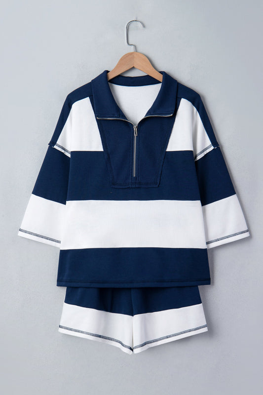 Navy and white striped shirt with matching shorts on a hanger against a gray background