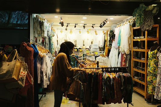 a person looking at a display of clothing