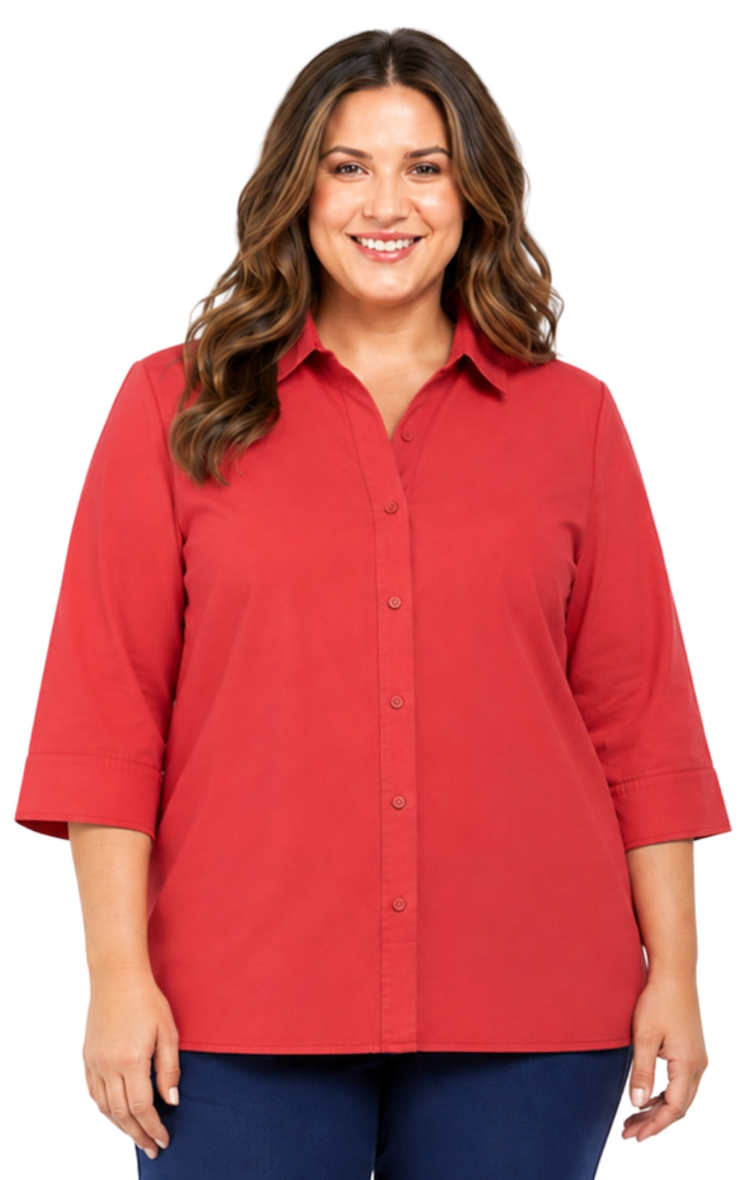 A smiling woman with wavy brown hair wearing a red button-down shirt with three-quarter sleeves and navy pants, photographed against a plain white background.