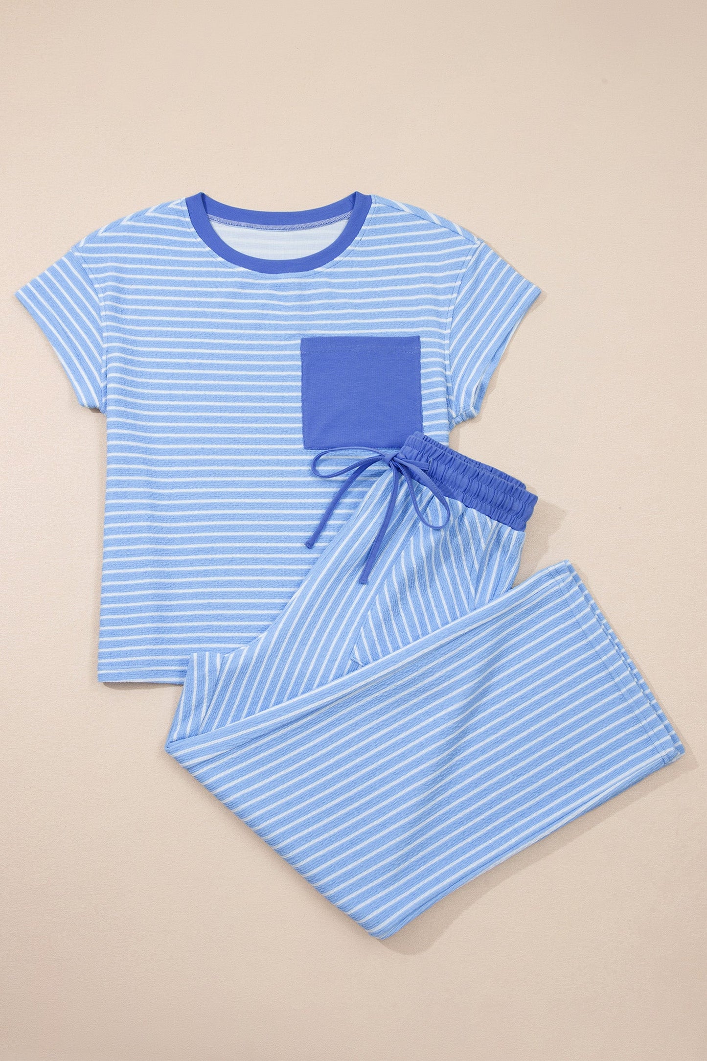 Blue striped pajama set on a beige background