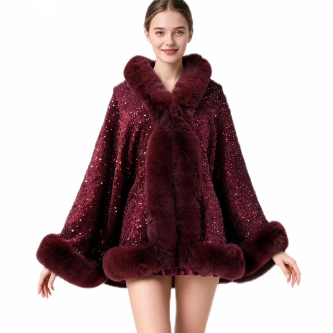 A woman modeling a luxurious deep burgundy faux fur cape jacket embellished with sparkling sequins, featuring a wide plush collar, matching cuffs, and a front closure, set against a plain white background.
