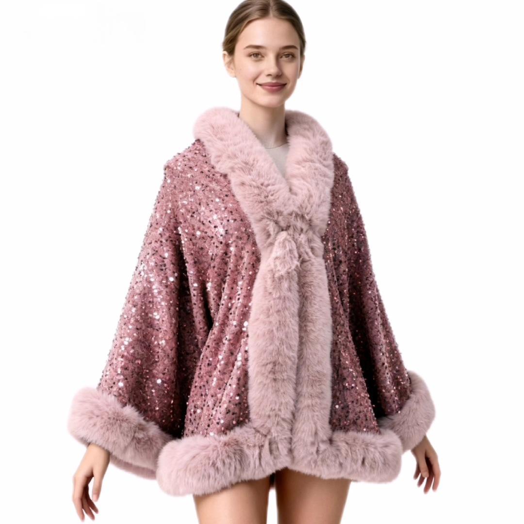 A woman modeling a pink sequined cape jacket with fluffy faux fur trim on a plain white background.