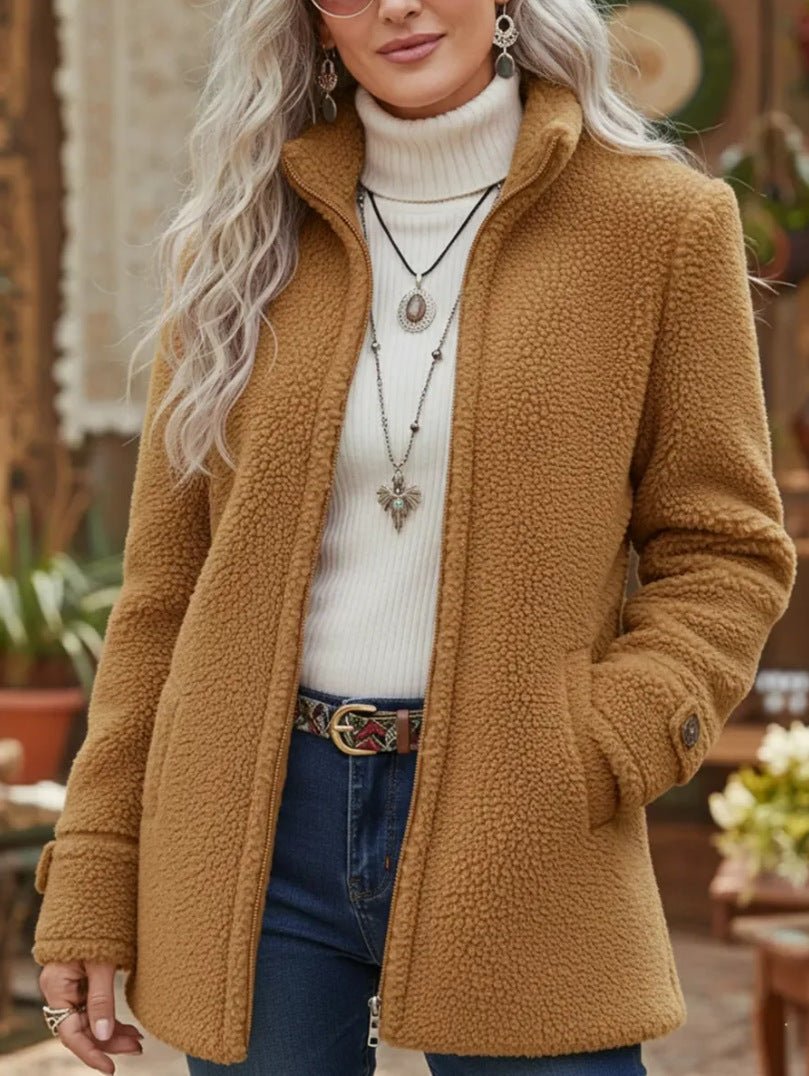 Woman wearing a brown fleece jacket with a blurred outdoor background