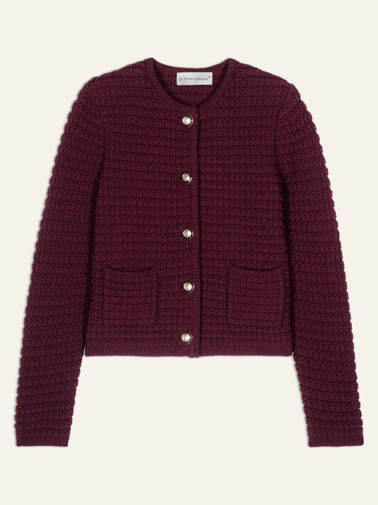 Women's burgundy knit cardigan laid flat, showing long sleeves, a round neckline, five buttons and two front pockets.