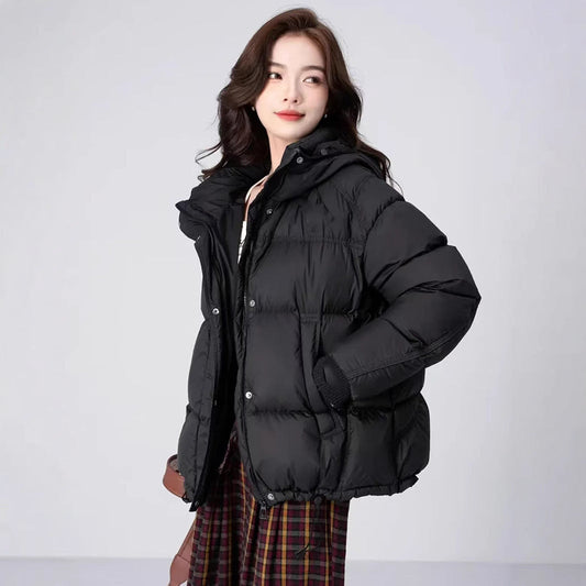 Woman wearing a black puffer jacket on a white background