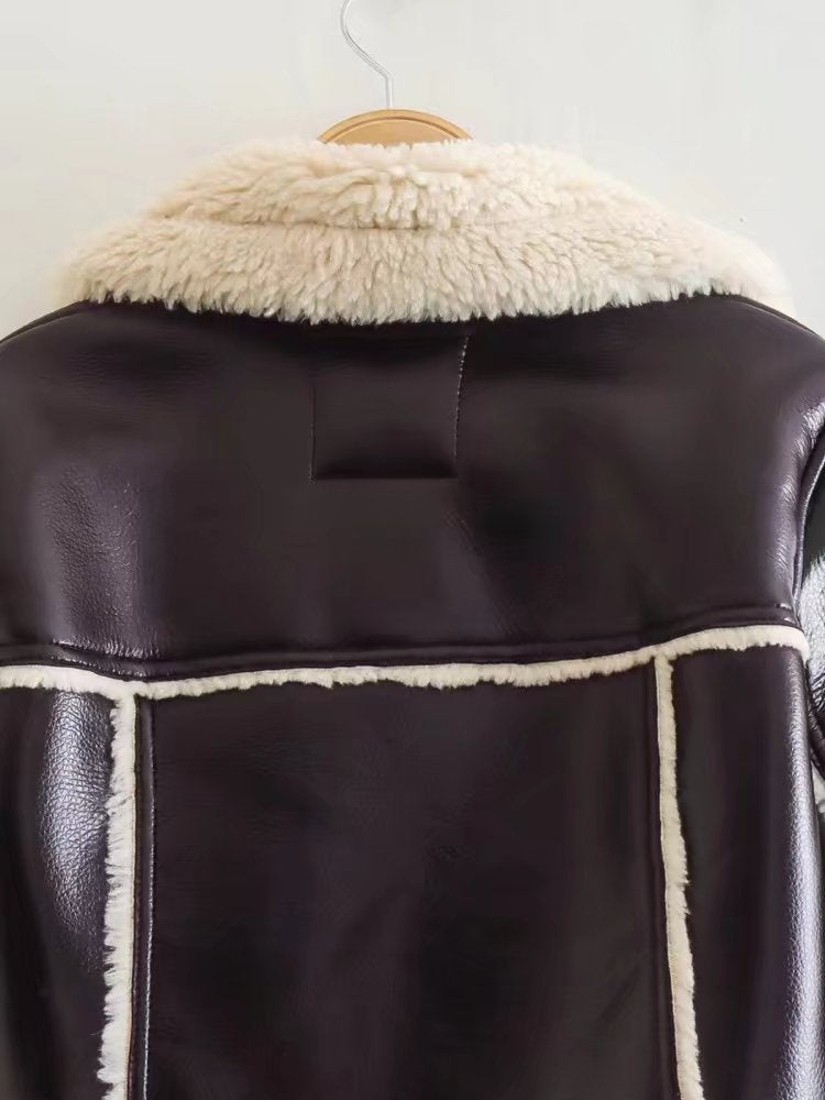 Brown leather jacket with white fur lining on a hanger against a white background
